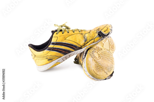 Old  worn out futsal sports shoes on white background soccer sportware object isolated