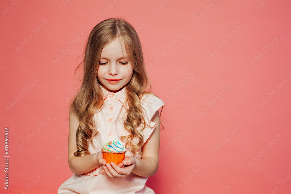 beautiful little girl blonde with cake and candy portrait of food