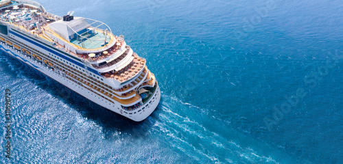 Aerial view of beautiful white cruise ship above luxury cruise close up at stern of cruise sail with contrail in the ocean sea  concept tourism travel take a vacation time on summer., webinar banner photo