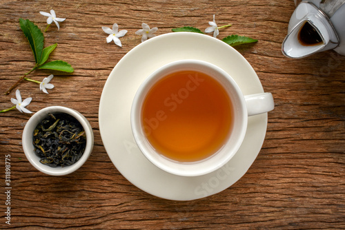 Cup of hot green tea on wood background. Chinese green tea known as healthy hot drink with antioxidant, also help with decrease fat in blood.