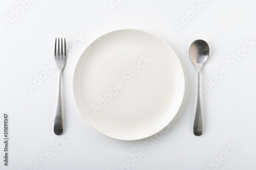 Fototapeta Empty plate spoon and fork