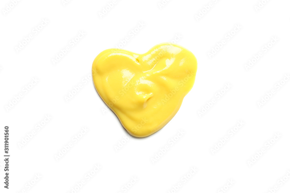 Fototapeta premium Heart made of yellow sauce isolated on white background