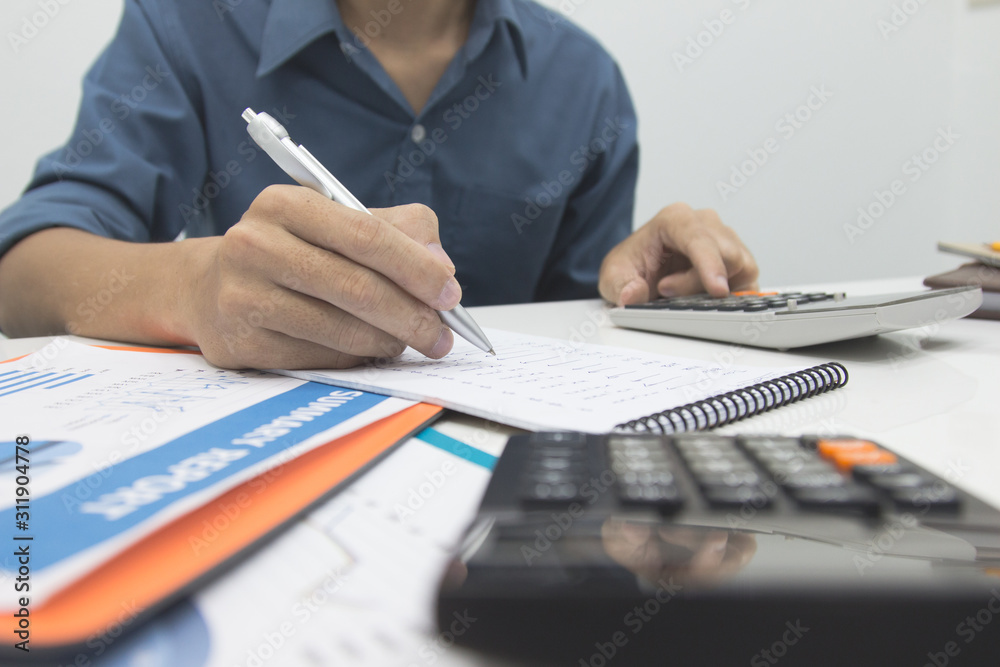 Business man  Writing expense information in home office.