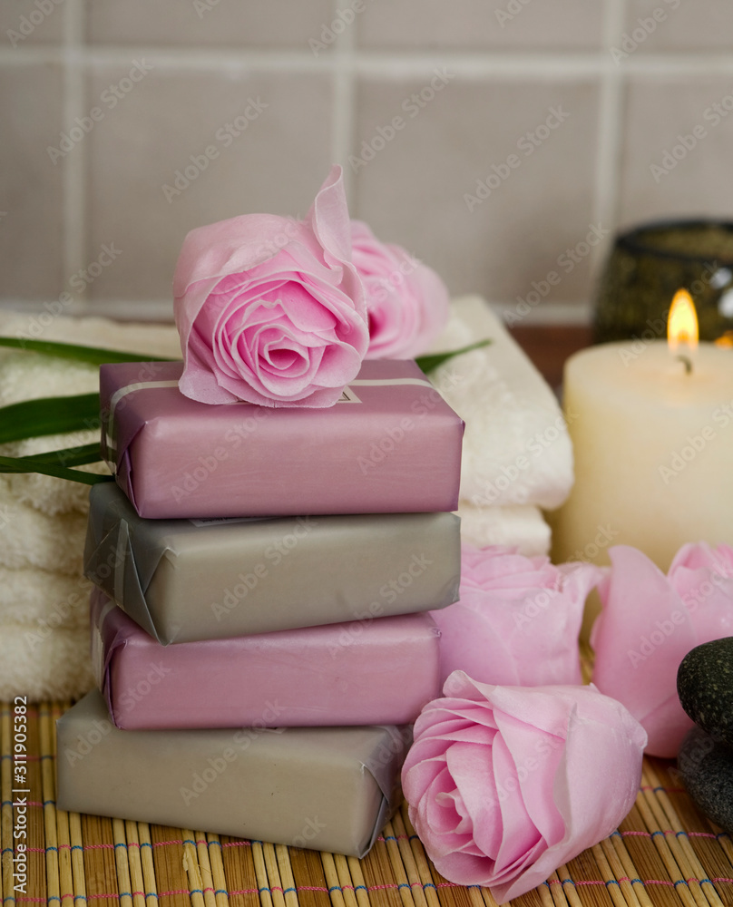 Soap pink roses.  candles and face towels in  a spa 