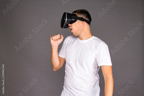 A guy in virtual reality glasses is dancing. Future and modern technologies