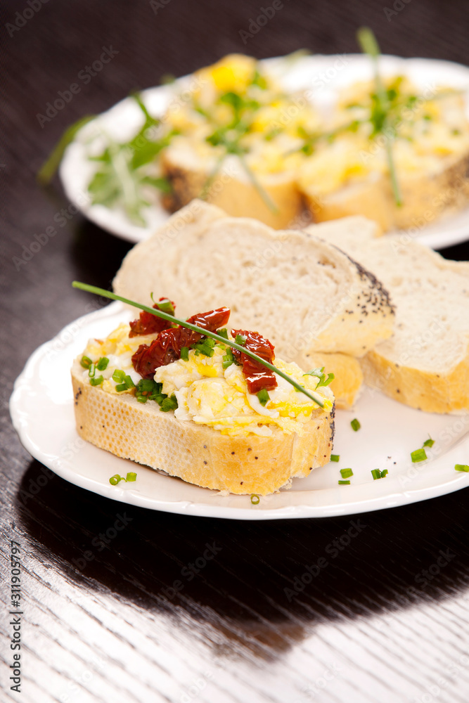 Delicious fresh scrambled eggs and dried tomatoes sandwich Delicious fresh scrambled eggs and dried tomatoes sandwich
