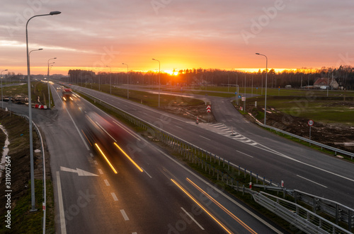 car traffic on the newly built section of the S6 expressway in Poland during sunset