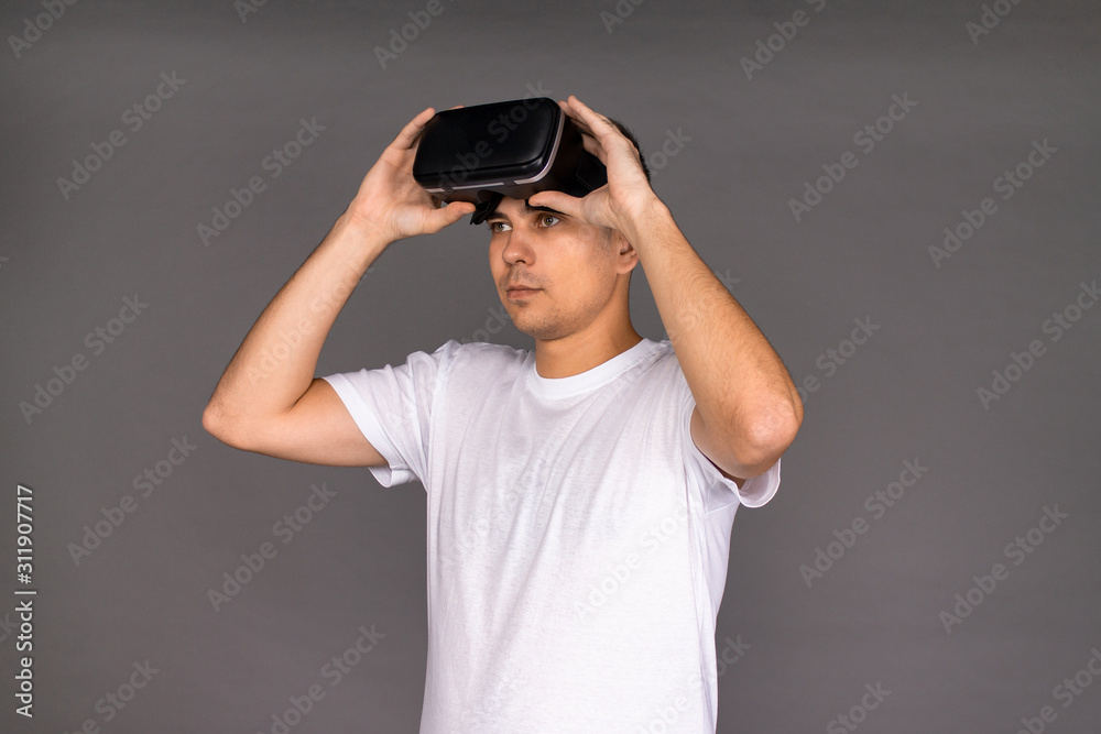Portrait of a guy in virtual reality glasses. Future and modern technologies