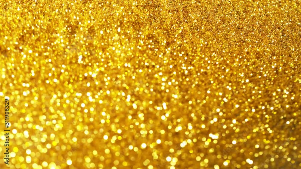 Super slow motion of glittering golden particles on black background. Shallow depth of focus. Filmed on high speed cinema camera, 1000 fps.