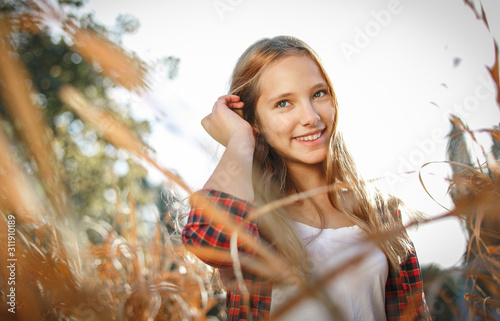 Lifestyle sunny outdoor portrait of young smiling teenage girl