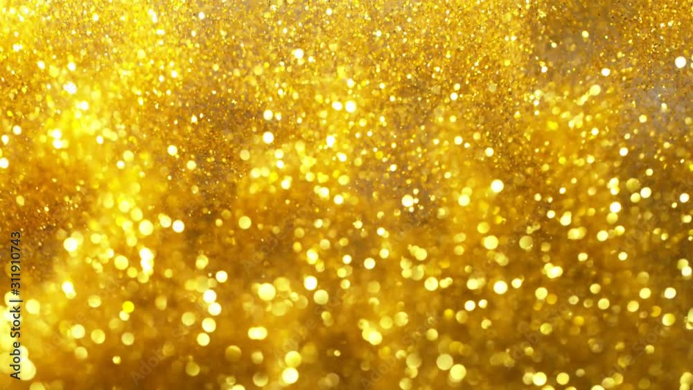Super slow motion of glittering golden particles on black background. Shallow depth of focus. Filmed on high speed cinema camera, 1000 fps. Super slow motion of glittering golden particles on black background. Shallow depth of focus. Filmed on high speed cinema camera, 1000 fps.