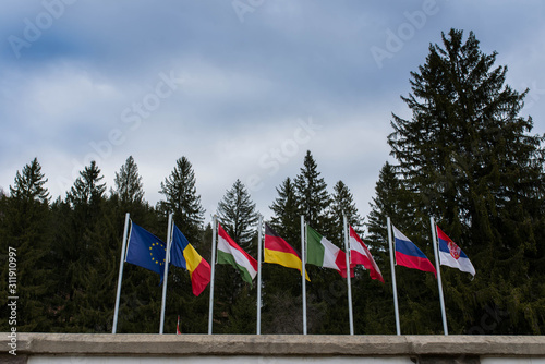 Waving european flags in local international World War 1 and 2 memorial park in Transylvania, Romania. photo