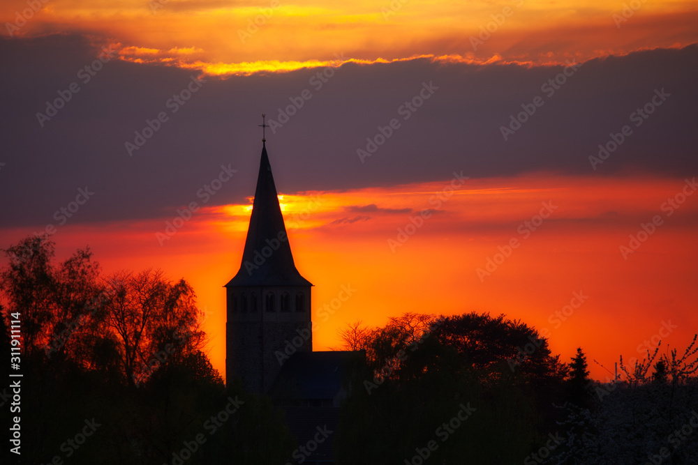 Fototapeta premium old church at sunset in ratingen homberg