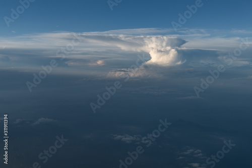 aerial view of an anvil cumulonimbus cloud from a plane with the typical anvil shape