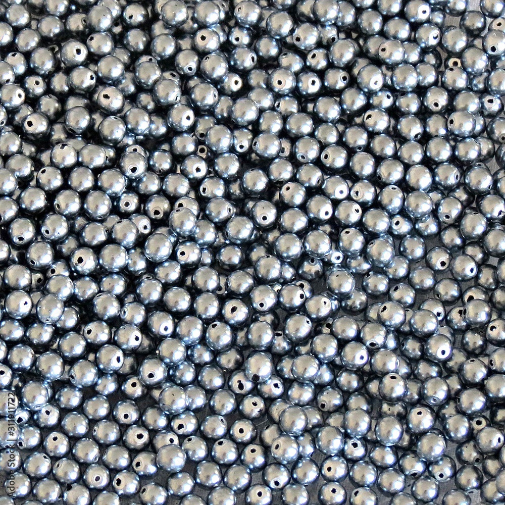 Gray glass beads for jewelry making. Hobby, handmade, crafts. Beads on the white background. Czech glass pearl beads.