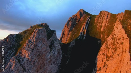 FPV aerial view panning over the Appenzell Alps, the Schaefler Ridge, at sunset, on a sunny summer evening, in Switzerland photo