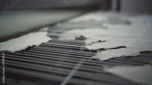 Automatic paint spraying machine in a leather factory.  