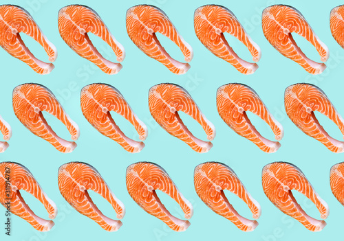 Salmon fish steaks isolated on blue background. Omega 3 vitamin, healthy lifestyle. Natural vegetarian food. Top view.
