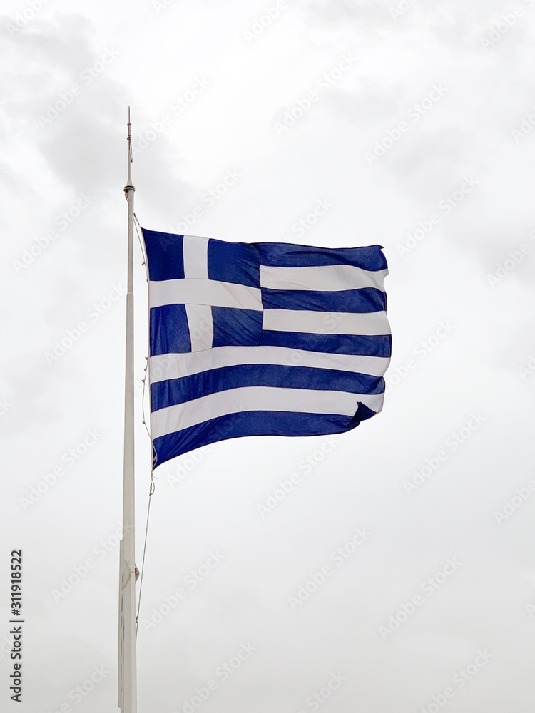 Waving national flag of Greece. Also called sky blue and white. Piece of fabric and a banner, used as patriotic country symbol. Nine equal and alternating horizontal stripes with a white cross