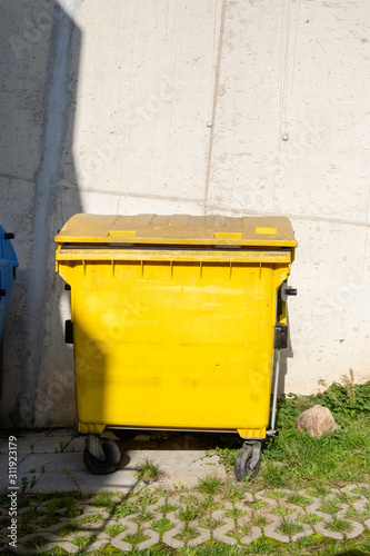 Yellow plastic trash can