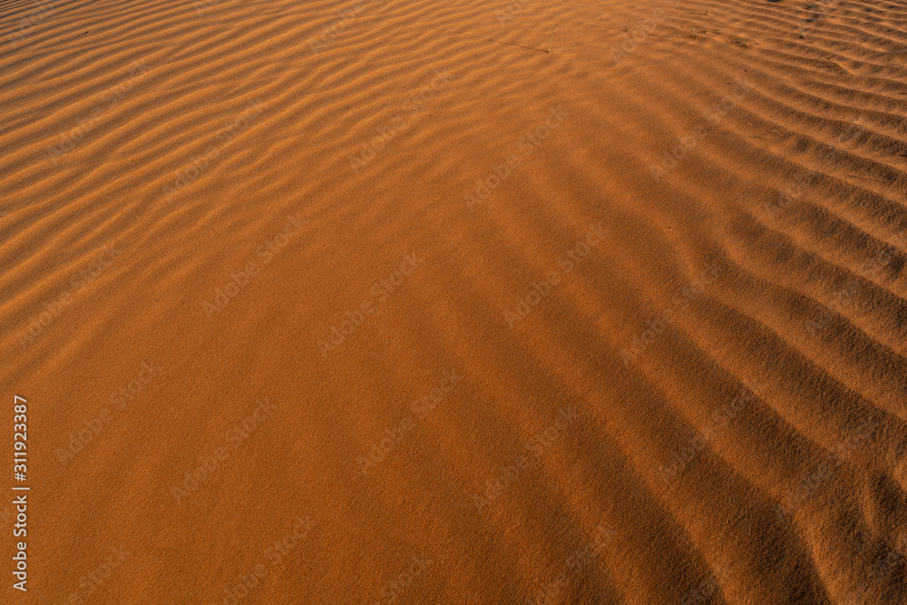 Red sand background with shadows from sunset sun, shot in desert at summer evening. Safari destination. Red sand background with shadows from sunset sun, shot in desert at summer evening. Safari destination.