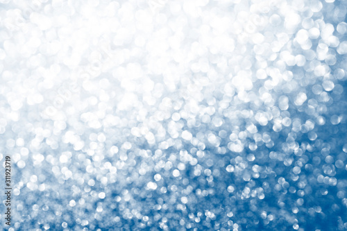 Bokeh, defocus background. Glare bokeh passing from silver to classic blue. Festive background. Copy space