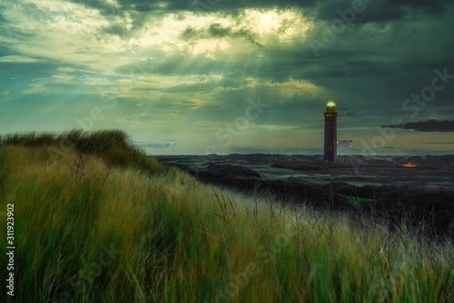 lighthouse at sunrise with sunbeams