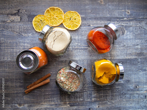 Bright aromatic spices in glass jars photo