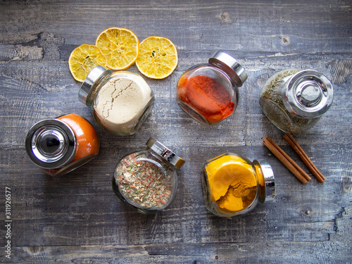 Bright aromatic spices in glass jars photo