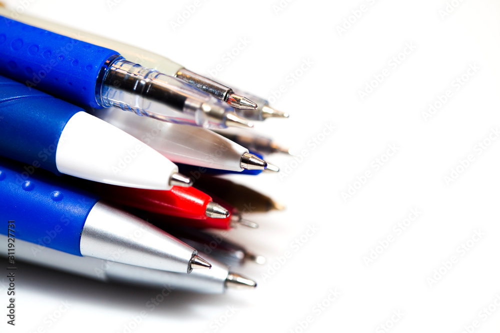 many different multi-colored pens isolated on white background many different multi-colored pens isolated on white background
