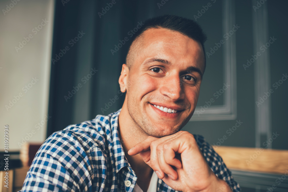 Naklejka premium Glad hipster relaxing in cafeteria