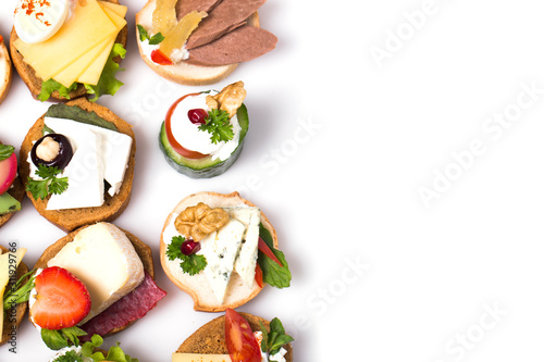 Many different canapes on a white background