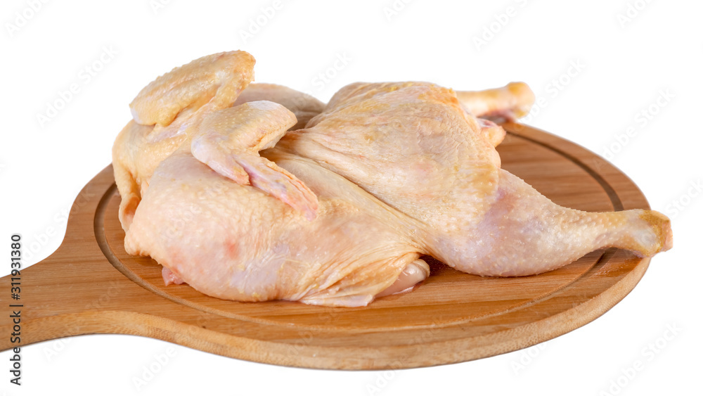 whole raw chicken on wooden cutting board isolated on white background