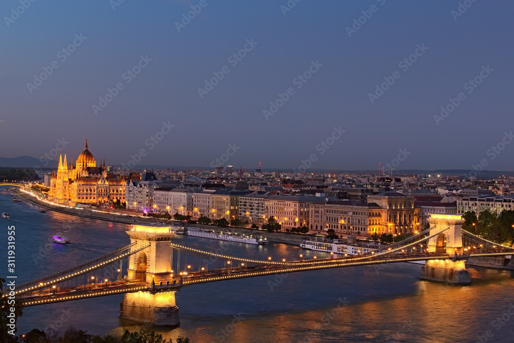Beautiful view downtown of Budapest. Night lights landscape with illuminated the Chain Bridge and The Hungarian Parliament Building. Landscape photo during blue hour. Budapest, Hungary