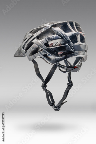 Studio Shot of Gray Camouflage Color Cycling Helmet. Three Quarters Back View of Protective Sports Equipment