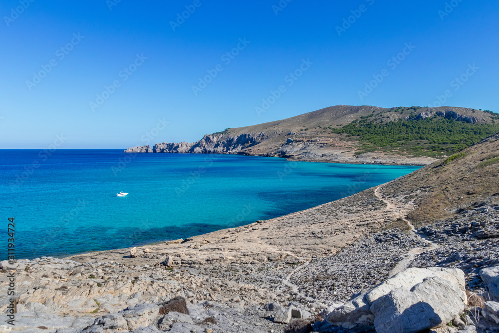 Fototapeta premium The beautiful coast shore of the island Mallorca in spain with a yacht in the clear blue water