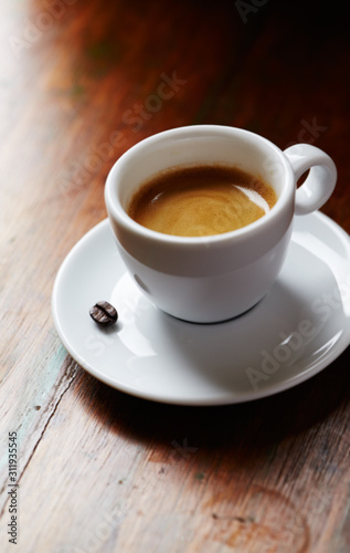 Cup of coffee on brown background. Close up.