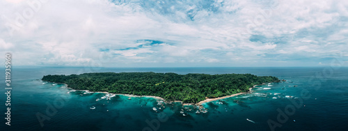 Aerial Drone View of a tropical island with lush jungle in Costa Rica, Isla del Caño photo