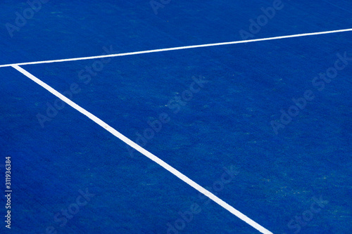 Blue paddle tennis court field with white lines background