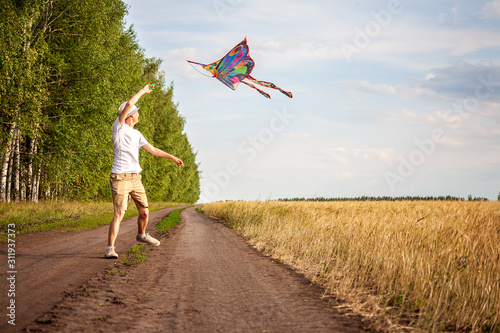 kite in hand against the blue sky in summer, flying kite launching, fun summer vacation, under the field, freedpm concept photo