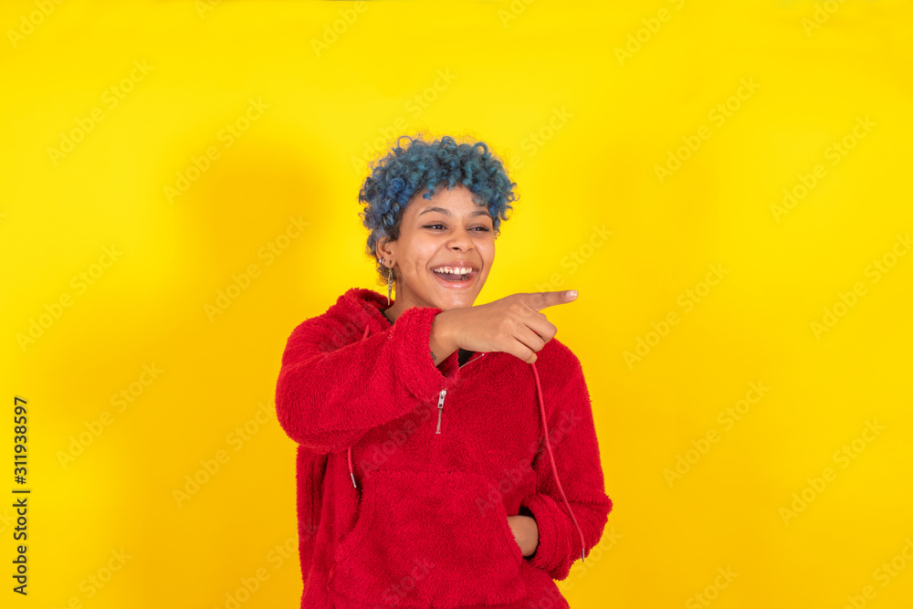 afro american woman isolated on color background pointing by hand