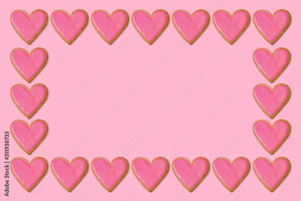 Valentine gift background. Pink heart cookie frame border. Love concept. Copy space Valentine gift background. Pink heart cookie frame border. Love concept. Copy space