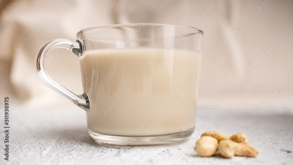 Glass cup with organic milk. Nut milk without lactose, gmo, antibiotics and casein. Diet drink. .. Glass cup with organic milk. Nut milk without lactose, gmo, antibiotics and casein. Diet drink. ..