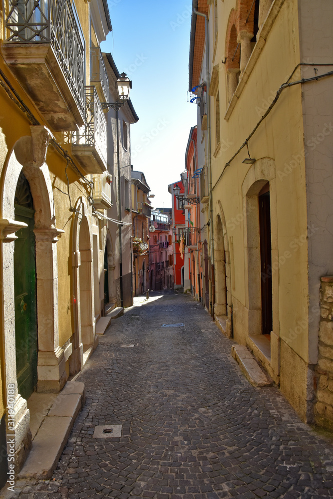 Fototapeta premium Campobasso, Italy, 24/12/2019. A narrow street between the old buildings of a medieval town