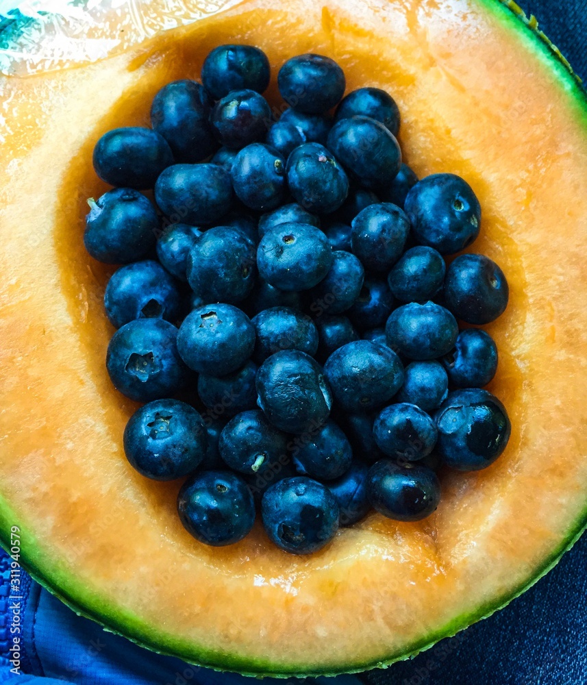 Fresh blueberries in a cantaloupe bowl