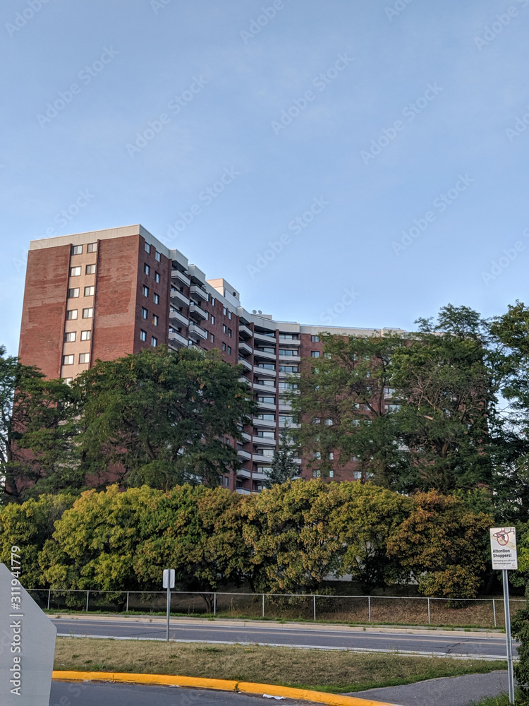 Large apartment buildings in Ottawa Ontario hidden behind greenery.
