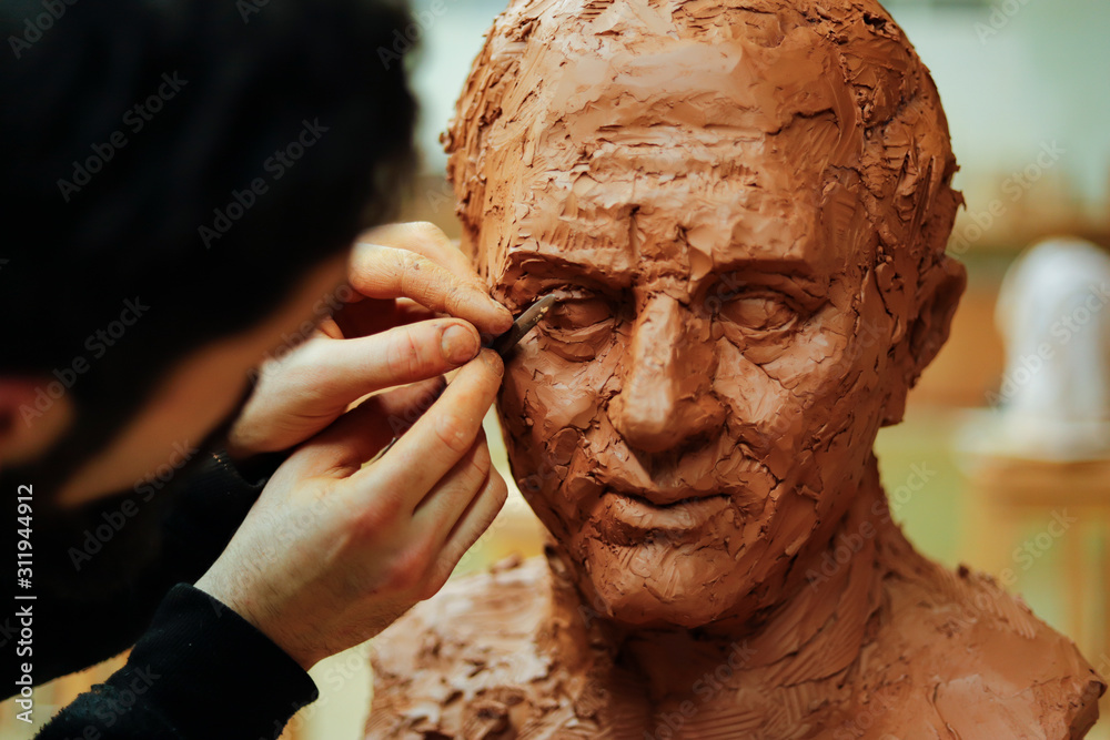 Close up of sculptor finishing an clay head eye - obrazy, fototapety, plakaty 