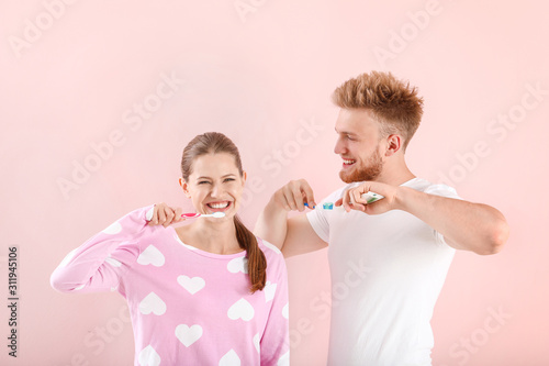 Young couple brushing teeth...