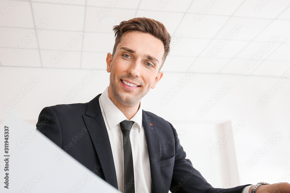 Handsome young businessman working in modern office Handsome young businessman working in modern office