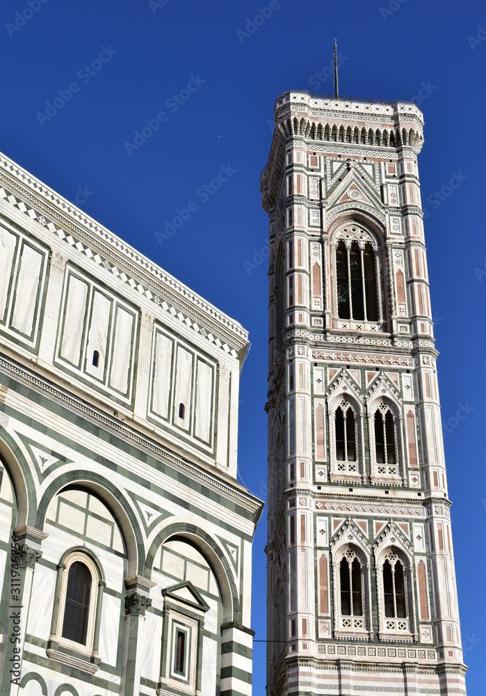 Campanile di Giotto and Battistero di San Giovanni from Piazza del Duomo with blue sky. Florence, Italy.